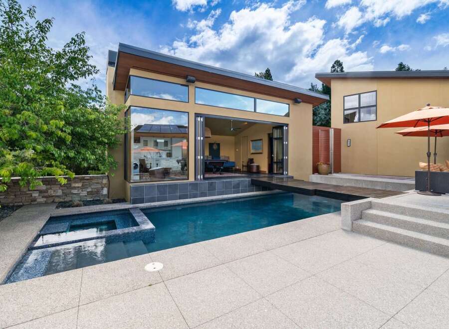 Experience luxury outdoor living with this stunning property featuring a sparkling swimming pool and an integrated spa, perfect for relaxation and entertainment.