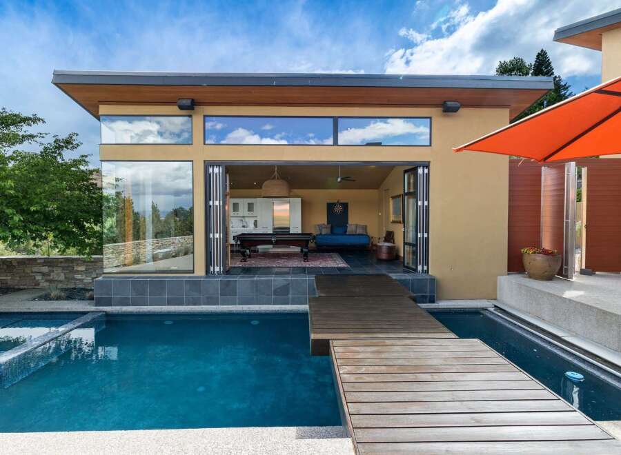 Experience modern luxury with this stunning property featuring a sleek design and an inviting outdoor living space.