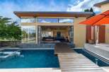 Experience modern luxury with this stunning property featuring a sleek design and an inviting outdoor living space.