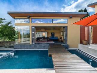 Experience modern luxury with this stunning property featuring a sleek design and an inviting outdoor living space.