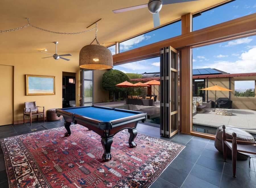 Experience ultimate relaxation and entertainment in this stunning home featuring a luxurious indoor pool area seamlessly connected to an outdoor oasis.