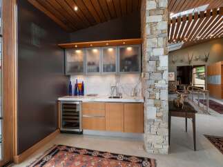 This stunning modern home features a sophisticated wet bar area, perfect for entertaining.