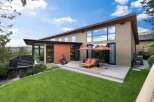 Experience modern luxury with this stunning home featuring expansive windows and a sleek, contemporary design.