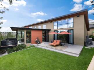 Experience modern luxury with this stunning home featuring expansive windows and a sleek, contemporary design.