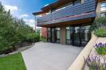 Experience modern living with this stunning home featuring a sleek balcony and expansive glass doors that open to a private patio.