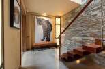 Experience modern luxury in this stunning entryway, featuring a dramatic leopard artwork and a sleek, minimalist bench.