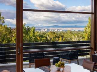 Experience breathtaking panoramic views of the city skyline and surrounding mountains from this stunning property.