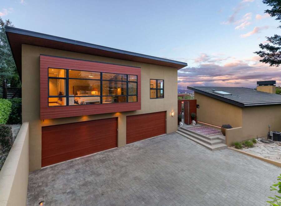 Experience modern luxury in this stunning home featuring a striking cantilevered bedroom with expansive windows offering panoramic views.