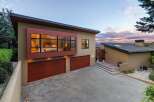 Experience modern luxury in this stunning home featuring a striking cantilevered bedroom with expansive windows offering panoramic views.