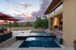 Experience luxury outdoor living with this stunning property featuring a modern infinity pool and expansive patio area, perfect for entertaining.