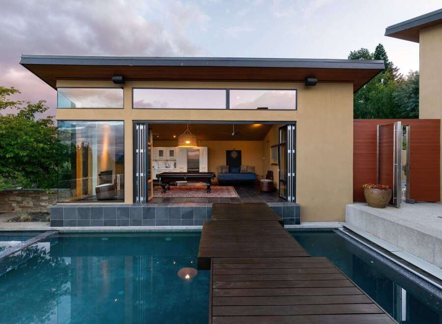 Experience seamless indoor-outdoor living with this stunning modern home featuring expansive bi-fold doors that open to a refreshing pool and entertainment area.