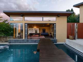 Experience seamless indoor-outdoor living with this stunning modern home featuring expansive bi-fold doors that open to a refreshing pool and entertainment area.