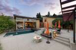 Experience luxury outdoor living with this stunning property featuring a modern home with expansive glass doors opening to a sparkling pool and spa.