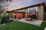 Experience modern luxury in this stunning home featuring expansive windows that capture breathtaking sunset views.