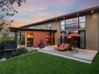 Experience modern luxury in this stunning home featuring expansive windows that capture breathtaking sunset views.