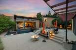 Experience luxury outdoor living with this stunning backyard oasis, featuring a modern pool and spa, a cozy fire pit, and a spacious patio perfect for entertaining.