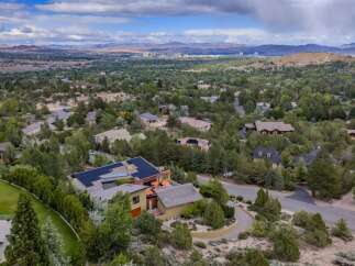 Experience luxury living in this stunning home, nestled amidst lush greenery and offering panoramic views of the distant city and mountains.