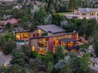 Experience luxury living in this stunning modern home nestled amidst lush greenery.