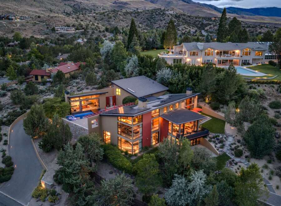 Experience luxury living in this modern architectural masterpiece nestled in a serene hillside setting.