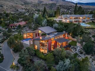 Experience luxury living in this modern architectural masterpiece nestled in a serene hillside setting.