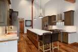 Experience luxury in this stunning gourmet kitchen, featuring a spacious island with a waterfall countertop and ample storage.