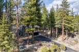 Nestled amidst towering pine trees, this stunning property offers a serene mountain retreat.