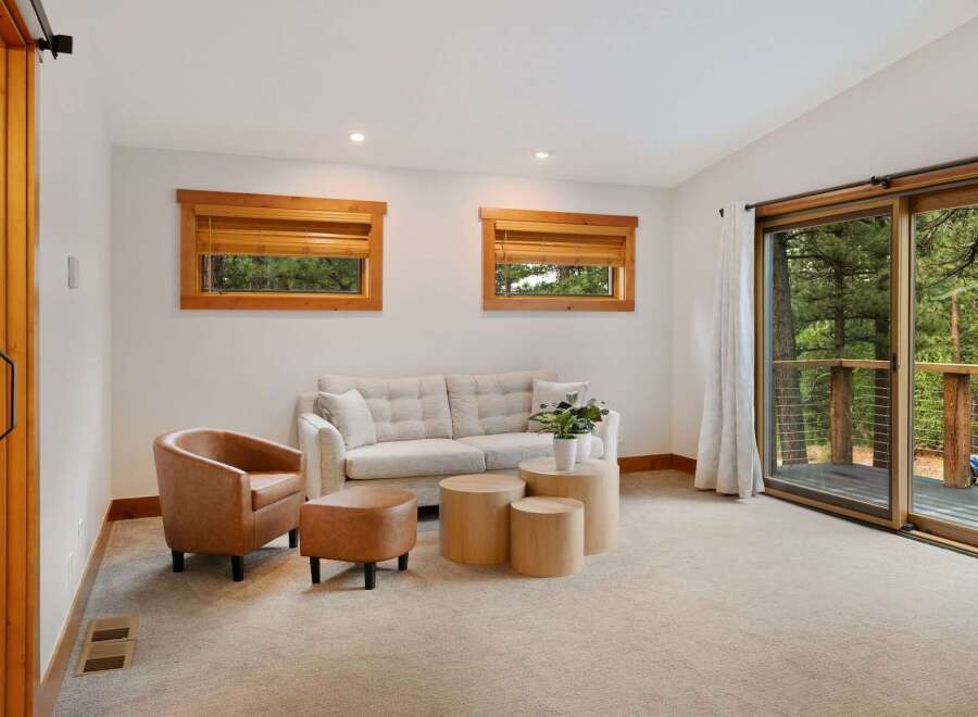 Experience cozy living in this inviting living room, featuring a plush sofa and a comfortable accent chair perfect for relaxation.