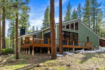 Experience modern mountain living in this stunning green home, nestled amongst tall pine trees.
