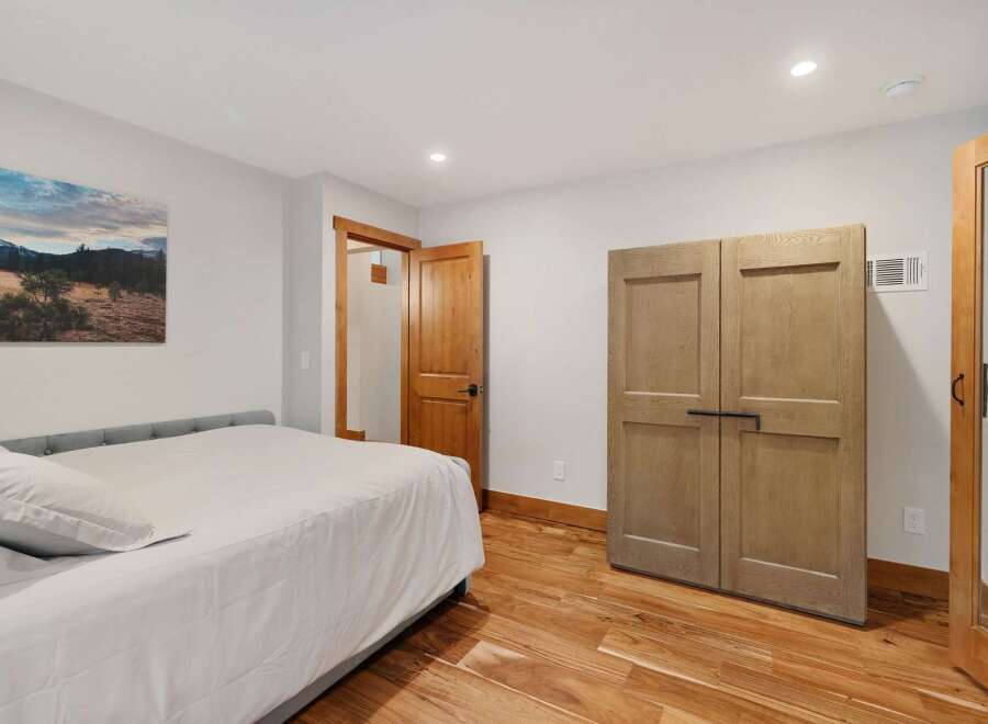 Discover this inviting bedroom featuring a comfortable bed and ample storage with a spacious double-door closet.