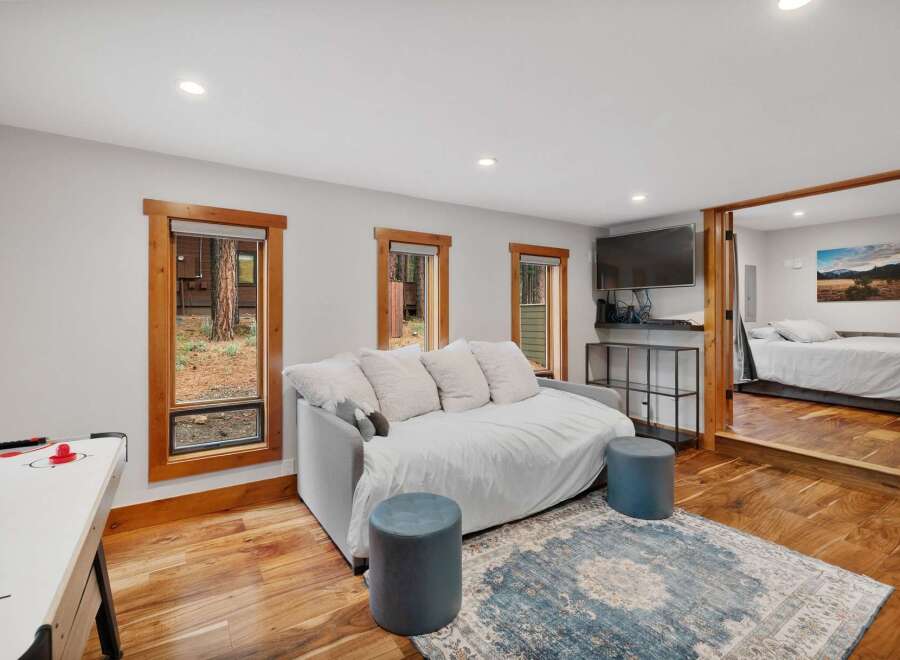Experience cozy living in this charming space featuring a comfortable daybed perfect for lounging or extra sleeping arrangements.