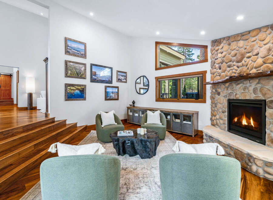 Experience luxury living in this stunning mountain retreat, featuring a grand stone fireplace and expansive windows that bring the outdoors in.