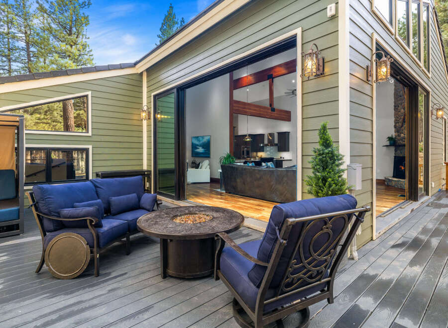 Enjoy outdoor living on this spacious deck featuring comfortable seating and a fire pit, perfect for gatherings.