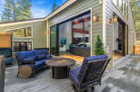 Enjoy outdoor living on this spacious deck featuring comfortable seating and a fire pit, perfect for gatherings.