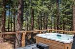 Experience ultimate relaxation in this stunning hot tub, nestled amidst a serene pine forest.