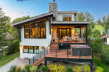 Experience modern mountain living in this stunning home featuring expansive windows and a multi-level deck perfect for entertaining.