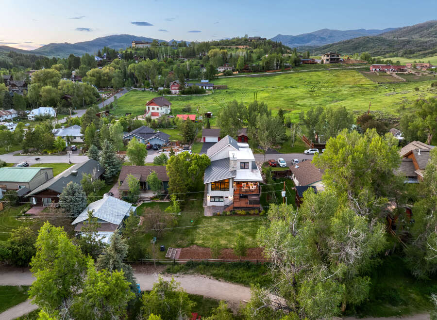 Experience luxury mountain living in this stunning modern home, featuring expansive decks and large windows that capture breathtaking views.