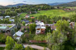 Experience luxury mountain living in this stunning modern home, featuring expansive decks and large windows that capture breathtaking views.