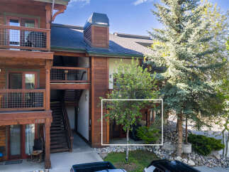 Experience mountain living in this charming condo featuring a rustic wood exterior and a private entrance.