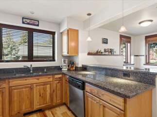 Discover this charming kitchen featuring warm, natural wood cabinetry and granite countertops.