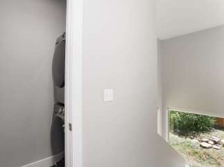 Discover modern living with this stacked washer and dryer unit, neatly tucked away for convenience.