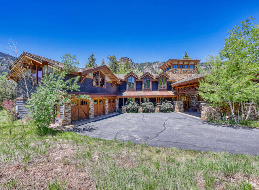 Experience luxury mountain living in this stunning custom-built home, featuring a striking stone and wood exterior that perfectly complements the natural surroundings.
