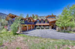 Experience luxury mountain living in this stunning custom-built home, featuring a striking stone and wood exterior that perfectly complements the natural surroundings.