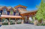 Experience luxury mountain living in this stunning custom-built home, featuring a striking stone and wood exterior that blends seamlessly with the natural landscape.