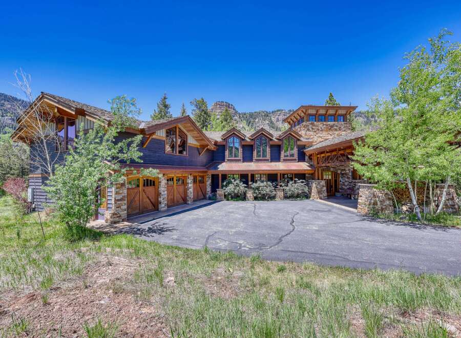Experience luxury mountain living in this stunning custom-built home, featuring a striking stone and wood exterior that perfectly complements the natural surroundings.
