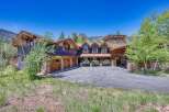 Experience luxury mountain living in this stunning custom-built home, featuring a striking stone and wood exterior that perfectly complements the natural surroundings.