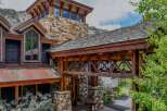 Experience rustic luxury in this stunning mountain home, featuring a unique stone and wood facade that blends seamlessly with the natural landscape.