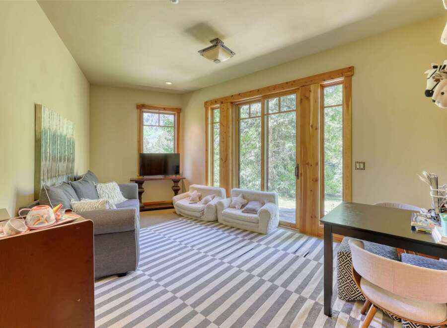 This inviting living space features a comfortable grey sofa adorned with plush pillows, perfect for relaxation.