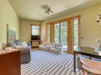 This inviting living space features a comfortable grey sofa adorned with plush pillows, perfect for relaxation.