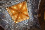 Experience rustic elegance with this stunning architectural design, featuring a dramatic stone-clad atrium that opens to a beautifully crafted wooden ceiling.