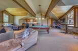 This spacious recreational room offers a perfect blend of relaxation and entertainment, featuring a full-size pool table and a well-equipped wet bar.